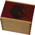A box made of purpleheart and avoidre, branded with the Unicorn Mon on the lid.